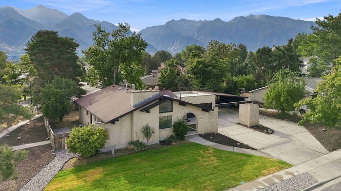 An aerial view of a home below the mountains edited by AutoHDR Iris