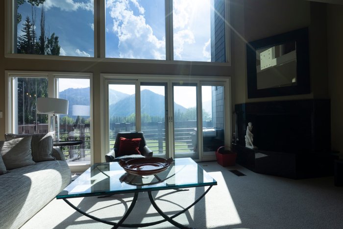 Mid bracket exposure of a living room with tall windows and a fireplace